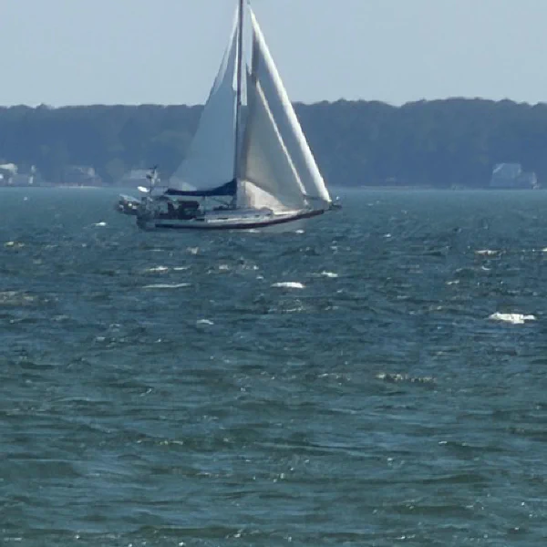 Defiant under sail with all three sheets