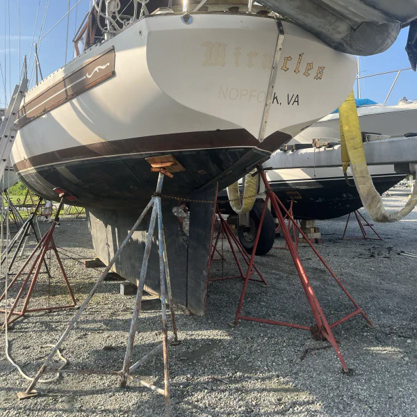 Everything was just tired. The topside paint was warn through, the bottom paint was gone, the teak runners raw and flaking off old Cetol