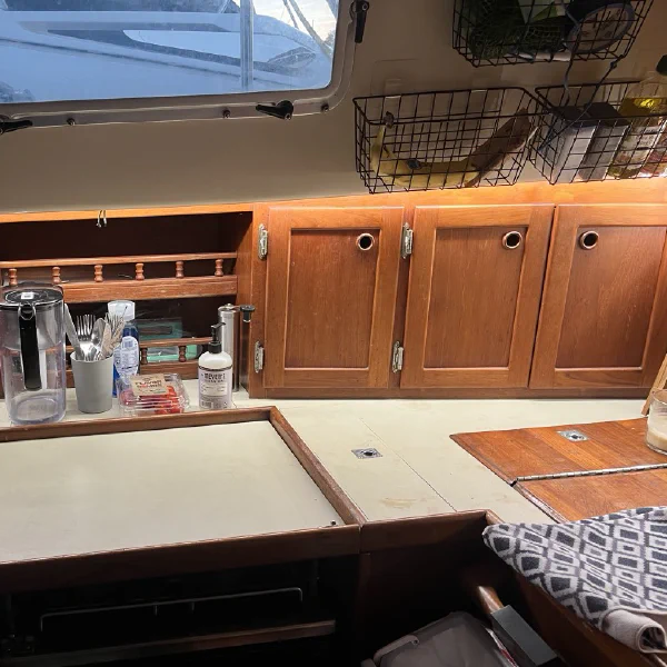 The starboard galley. Top-load refrigerator far aft, gimballed stove, and sink forward